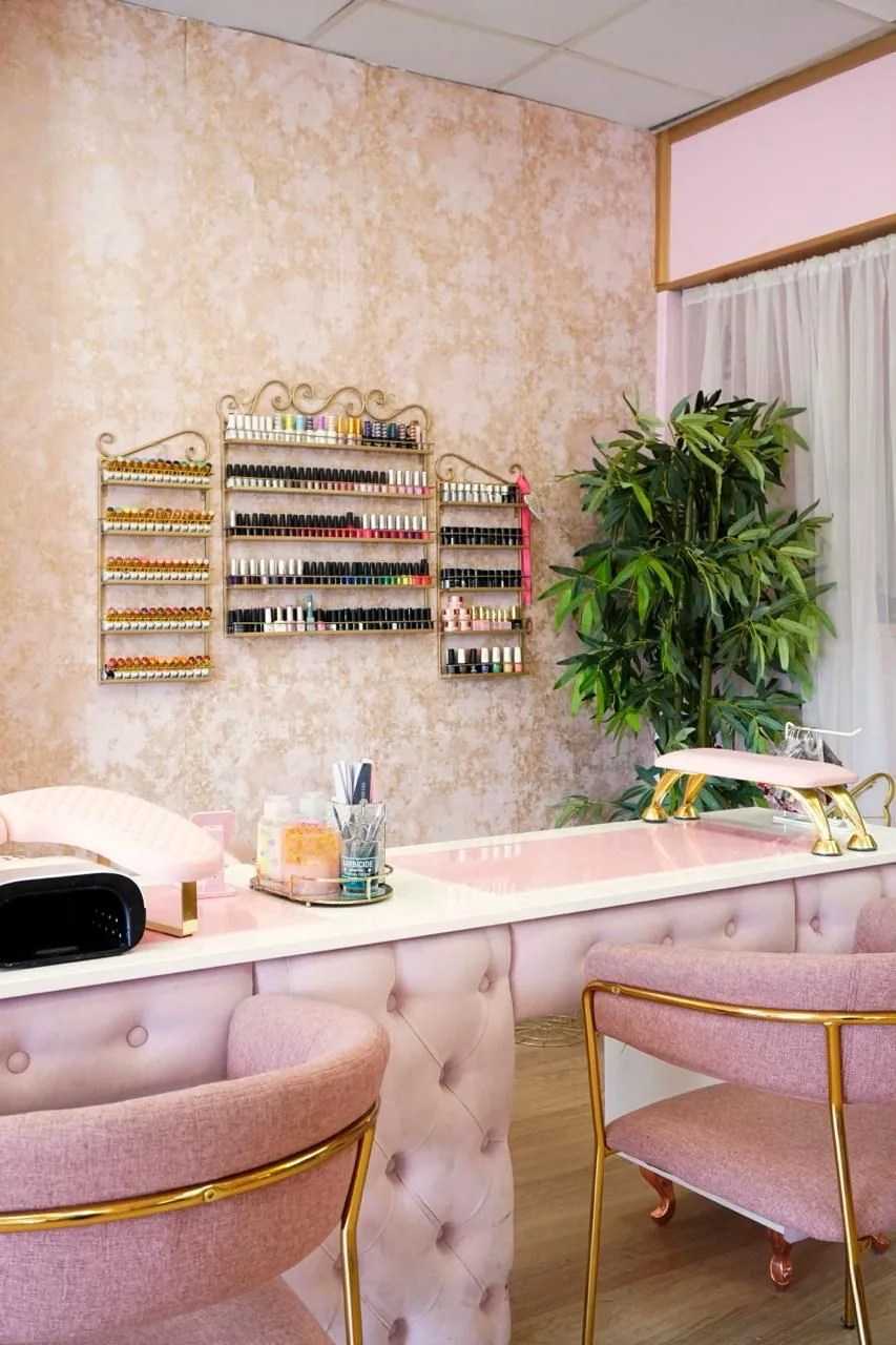 Pink velvet chairs and gold details at Naturally U’s manicure desks