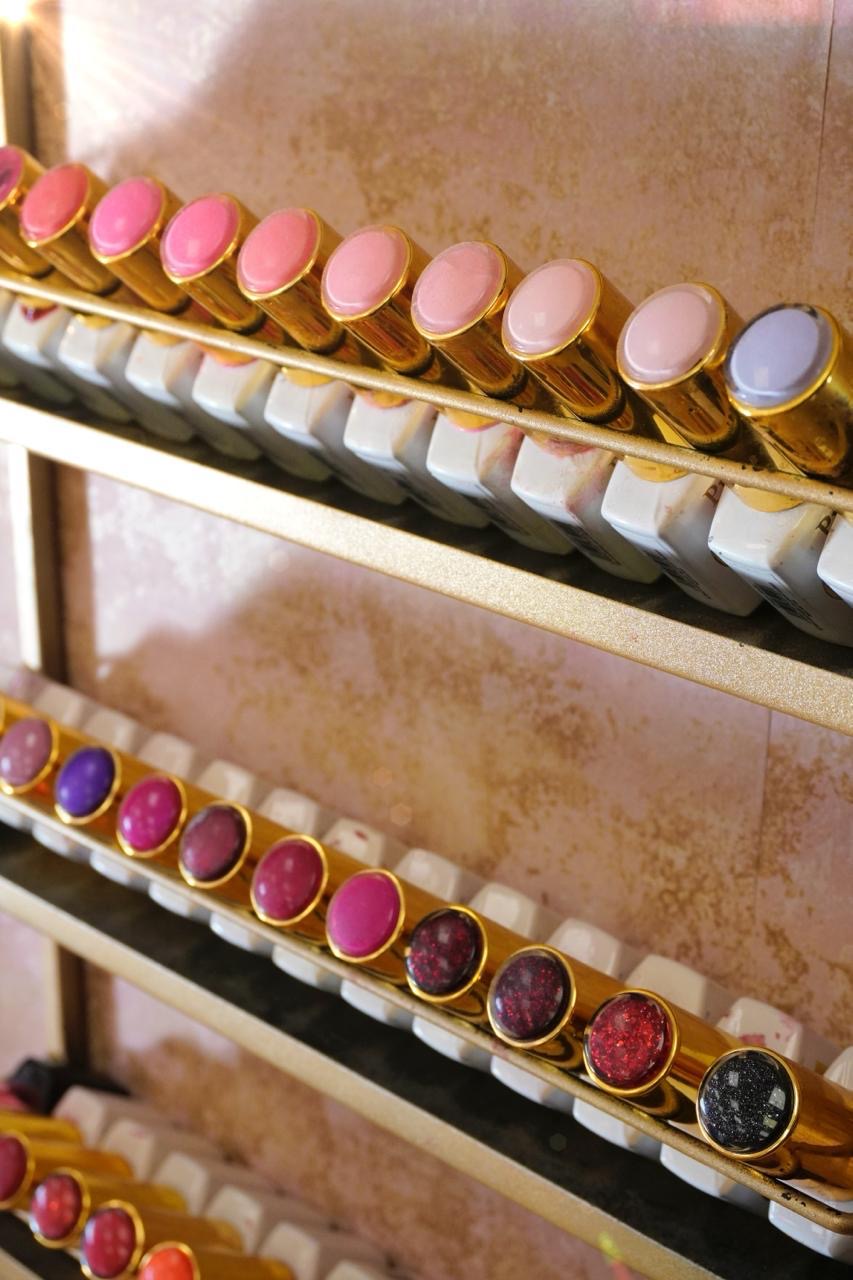 A spectrum of pink nail shades in gold-topped bottles