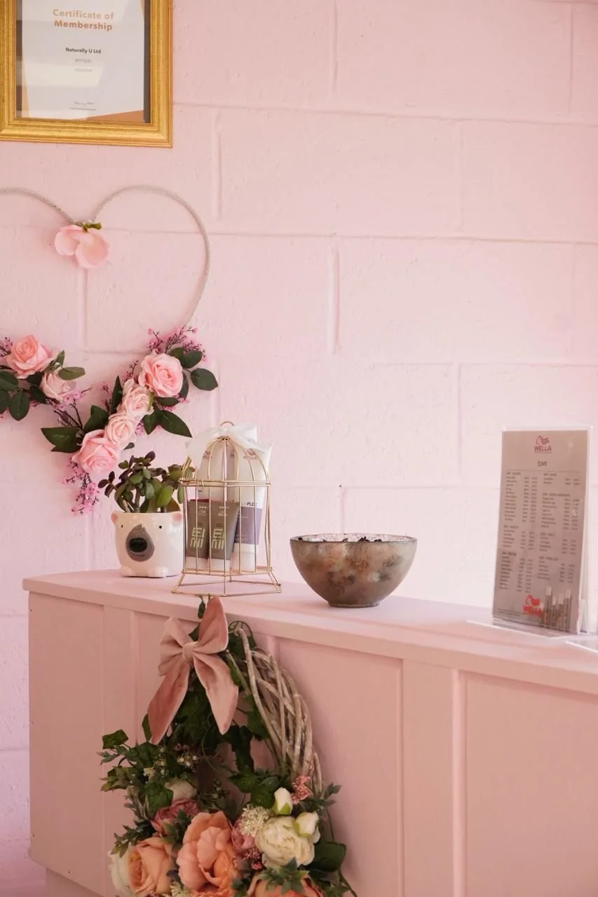 Wella haircare on display at Naturally U’s pink reception desk