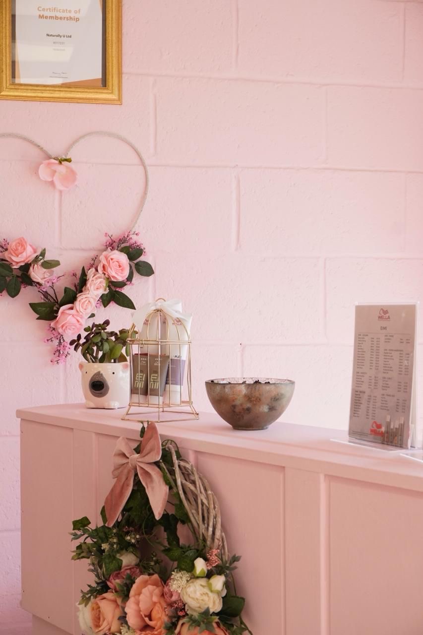 Wella haircare on display at Naturally U’s pink reception desk